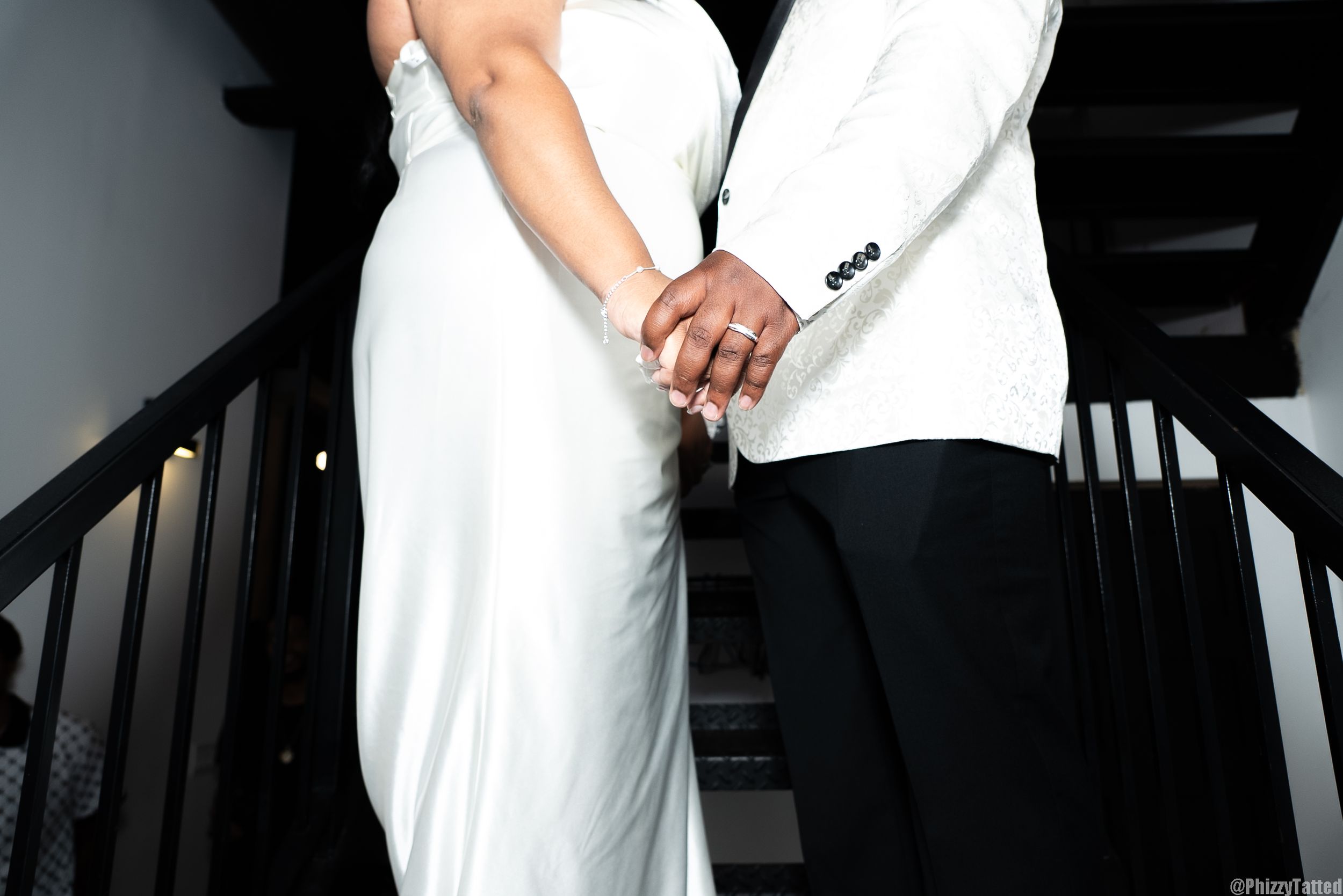 Series of cropped shots showing formal white dress details in dark lighting.