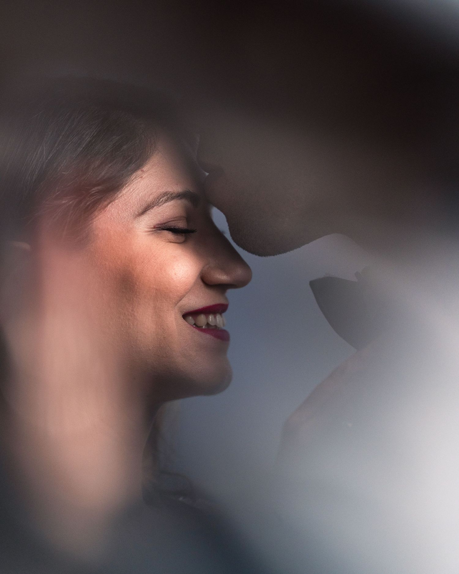 Artistic side profile portrait with dreamy lighting and soft focus.