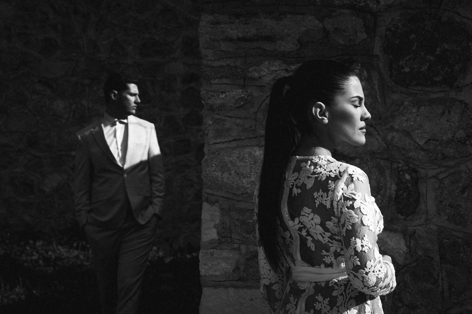 Dramatic black and white portrait with architectural elements.