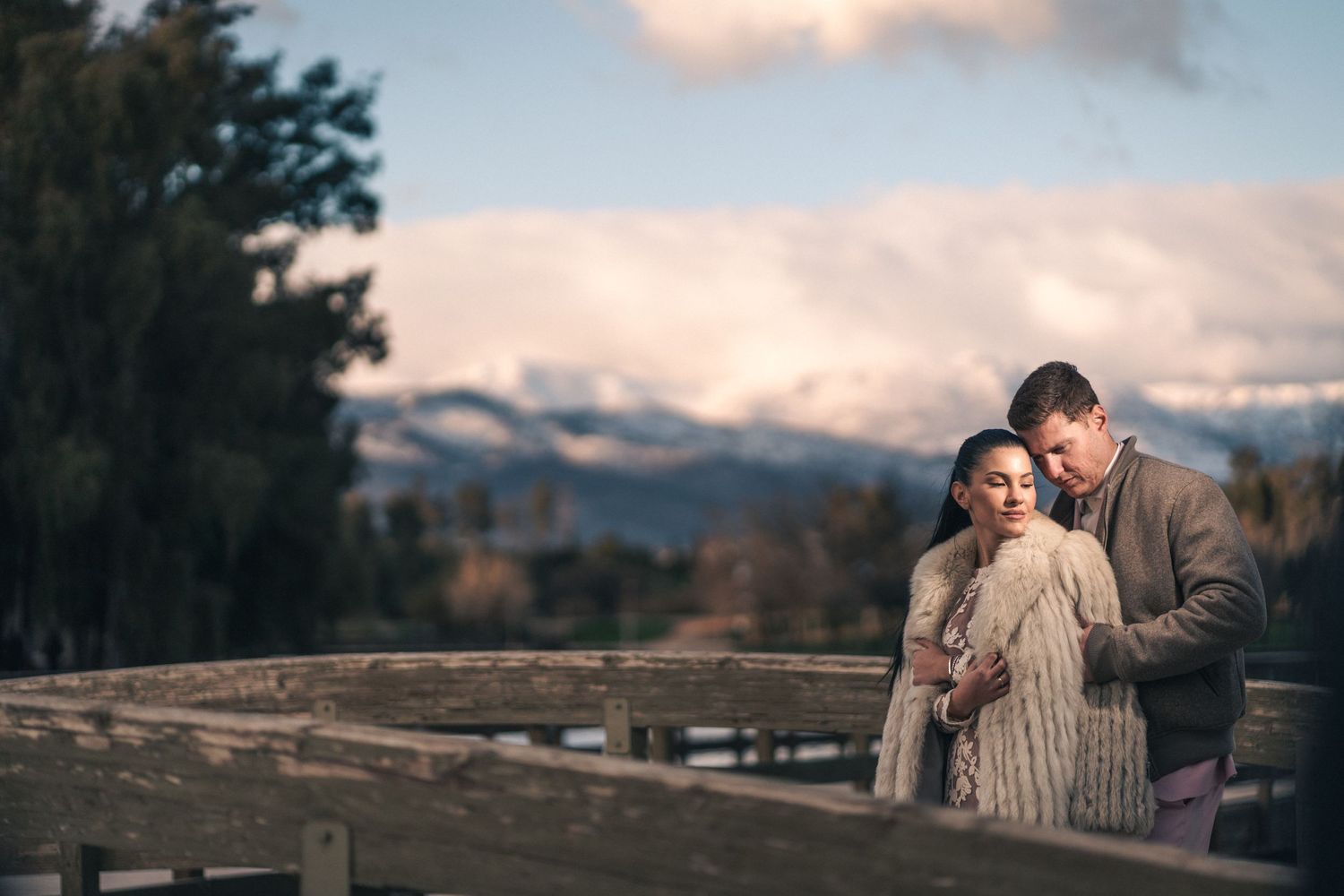 Romantic winter scene with mountain landscape in the background.
