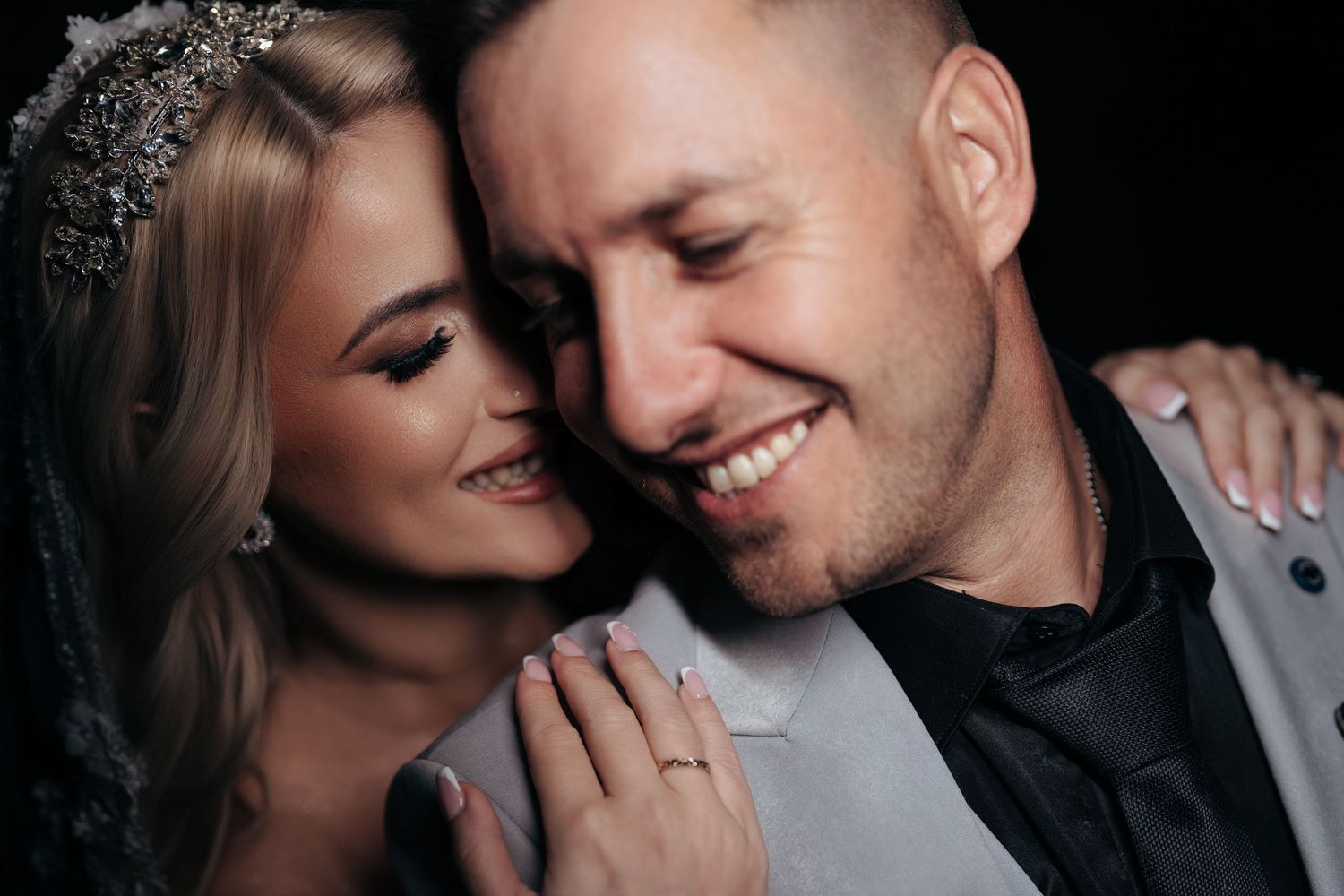 A romantic close-up portrait of a newlywed couple sharing an intimate moment together.