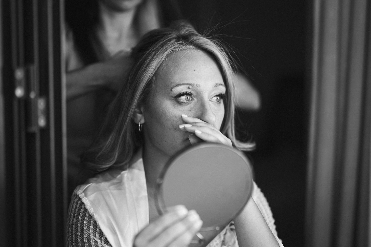 Dramatic monochrome wedding photography series showing tender moments between newlyweds.