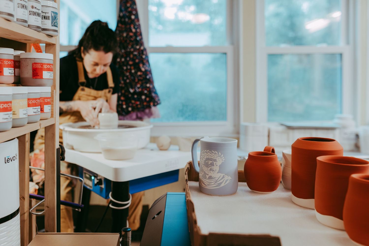 Woman at pottery wheel creating. Whitney Popp, Arizona photographer.