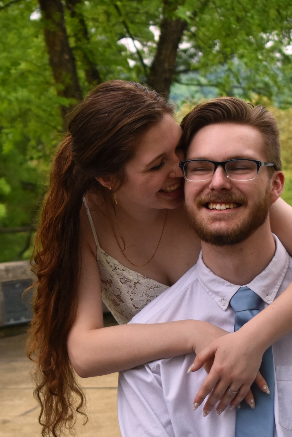 Intimate close-up portrait of couple sharing joyful moment outdoors.