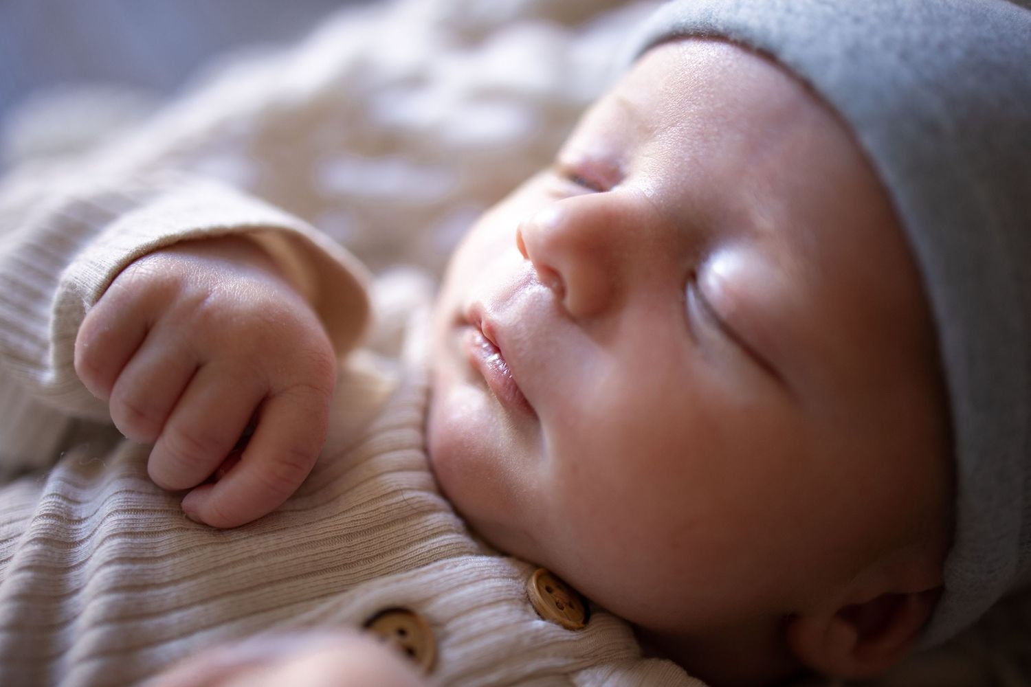 Springfield Il Newborn Photographer captures close up of a newborn's hand, mouth and nose during a lifestyle newborn session.