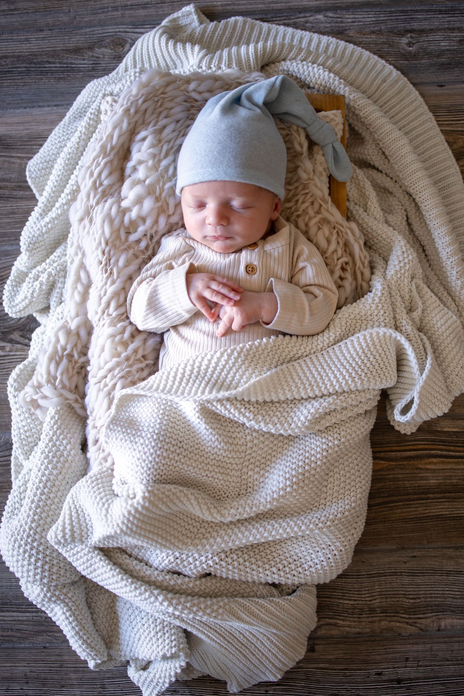 Springfield, IL Newborn Photographer captures an overhead photo of a newborn sleeping swaddled in blankets during a newborn session