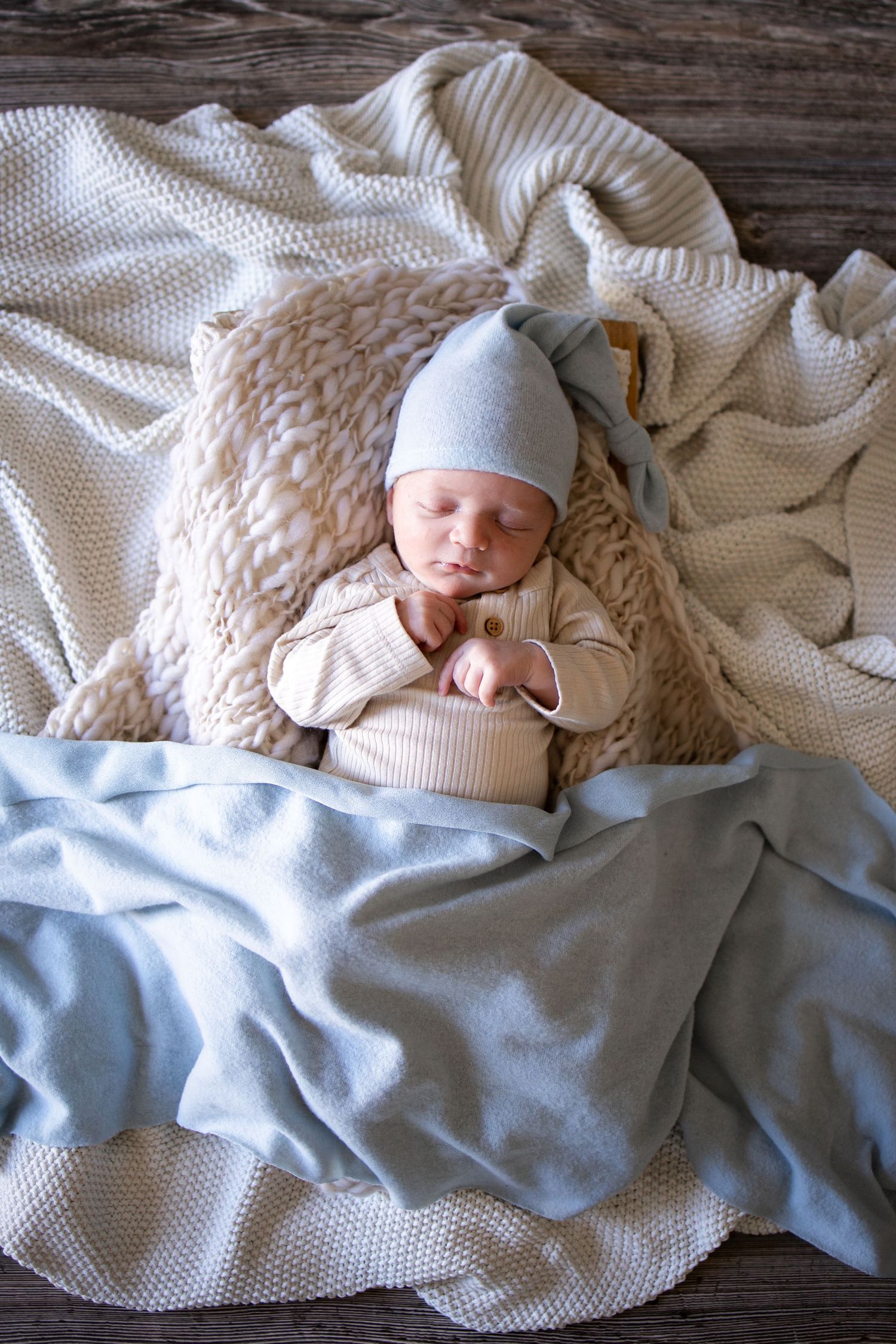 Springfield, IL Newborn Photographer captures a newborn sleeping with a swaddle during a lifestyle newborn session in Central, IL
