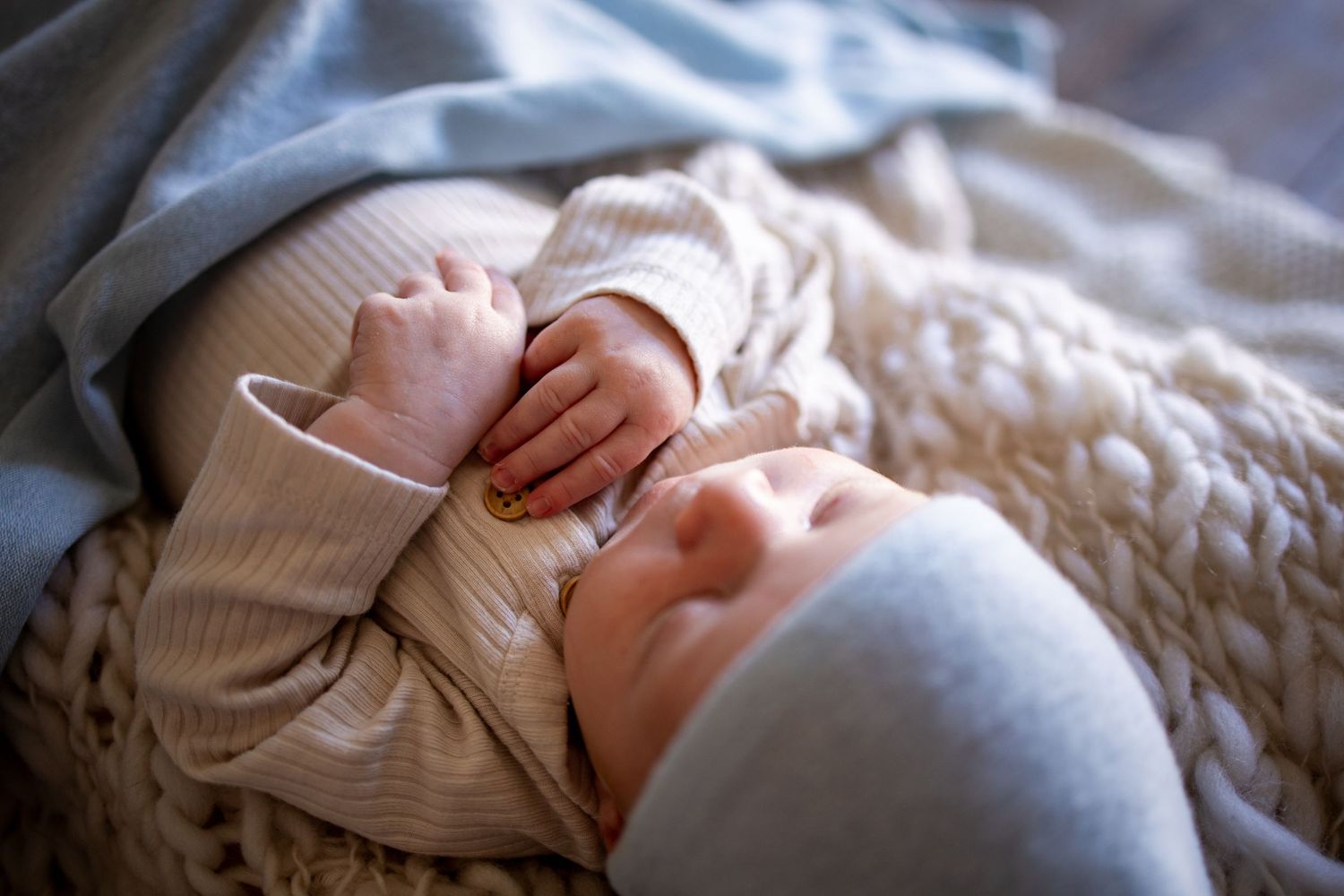 Springfield, IL Newborn Photographer captures a newborn's nose and hands while swaddled in blankets during a lifestyle newborn session