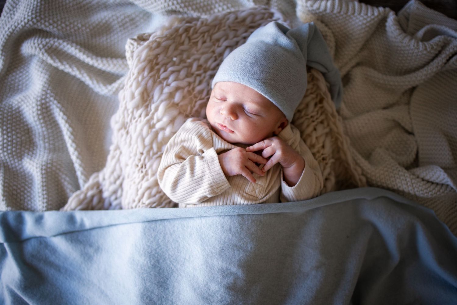 Springfield, IL Newborn Photographer captures a newborn swaddled up while laying on blankets during a lifestyle newborn session