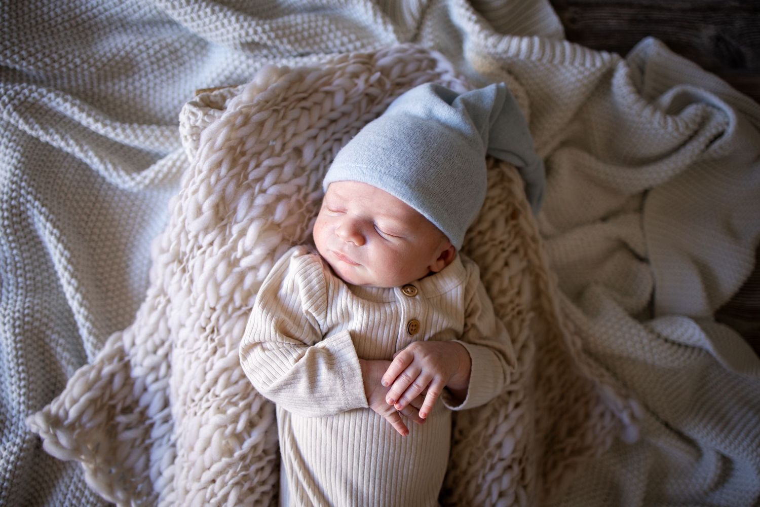 Springfield Il Newborn Photographer captures baby laying peacefully on blankets during a lifestyle newborn session