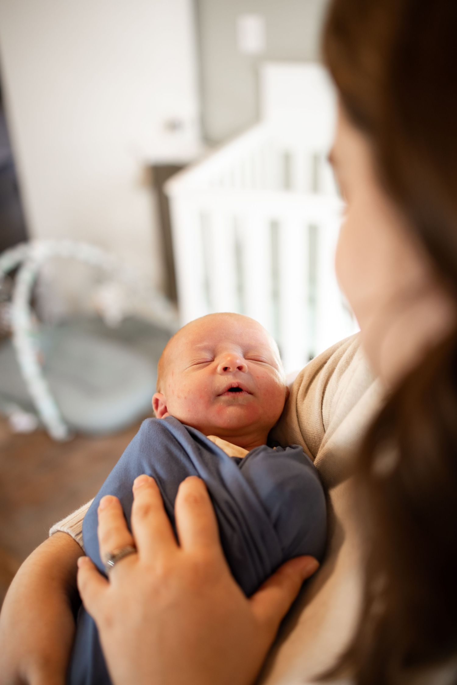 Springfield, IL Newborn Photographer captures a mom holding her newborn during a lifestyle newborn session in Central, IL