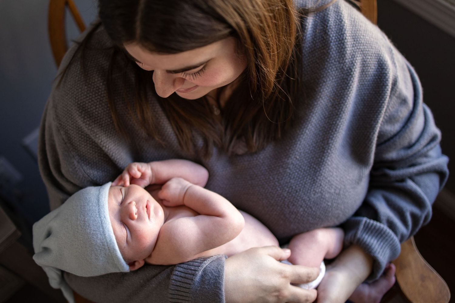 Springfield Il Newborn Photographer captures mom holding baby during a lifestyle newborn session