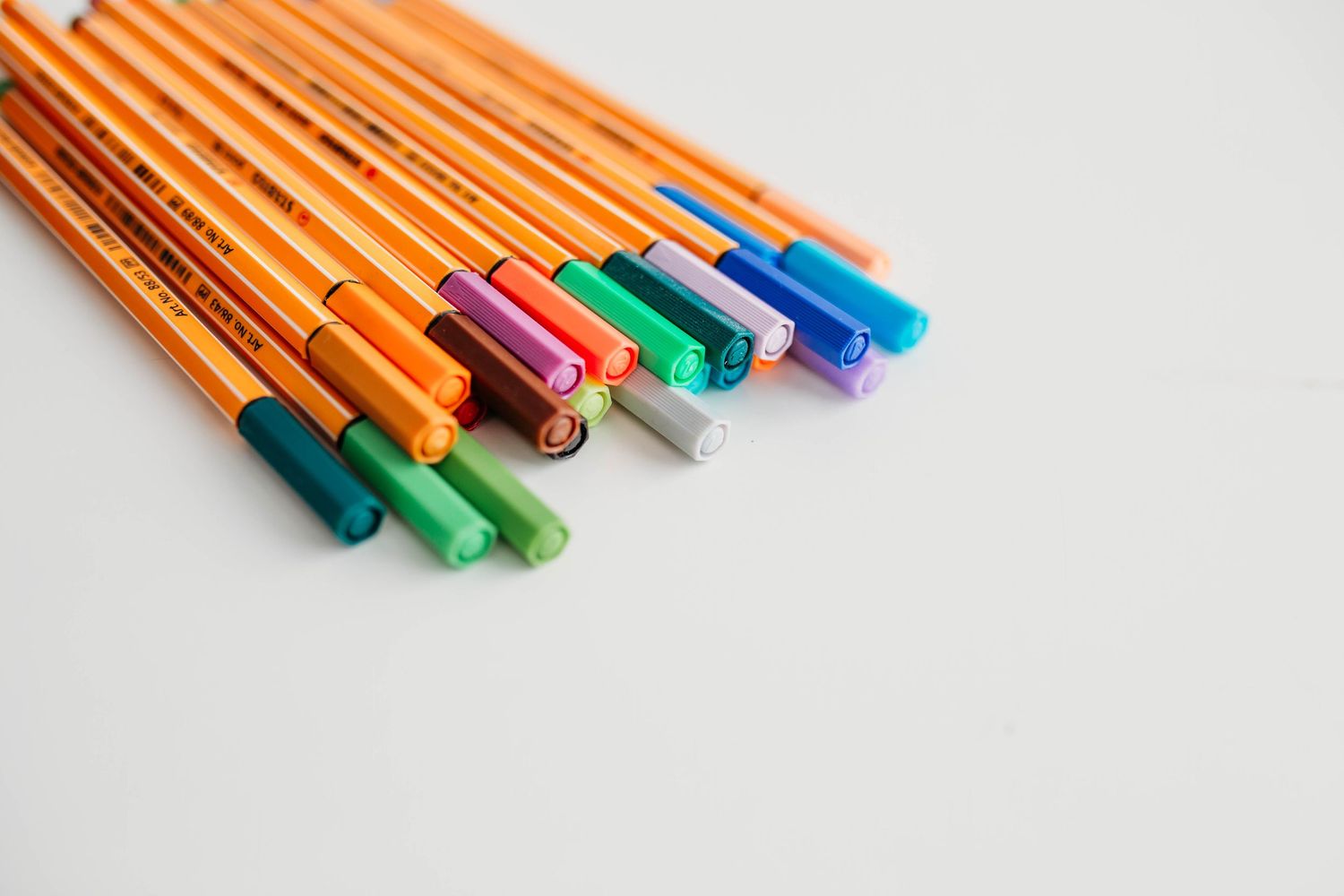A collection of colorful Stabilo point 88 fineliner pens arranged diagonally on a white background.