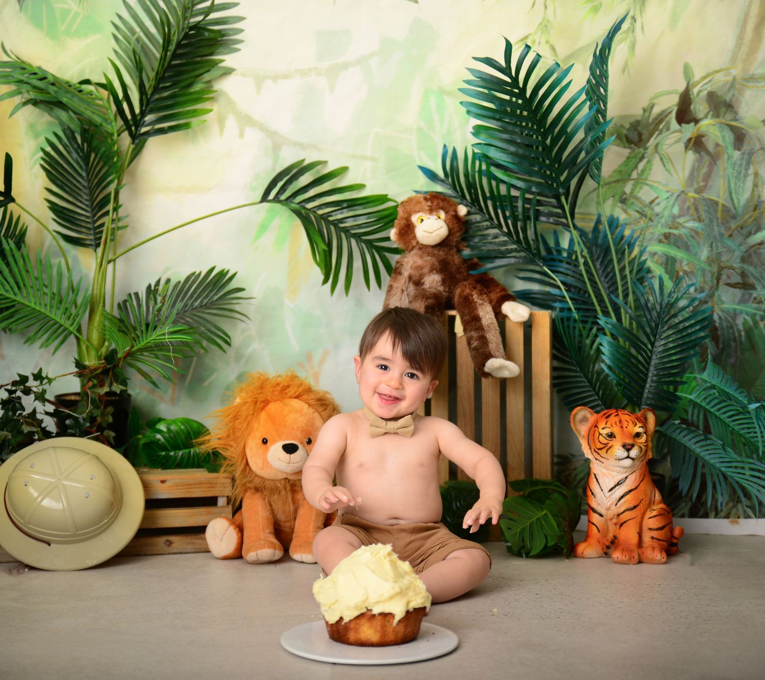 Toddler celebrating first birthday cake smash jungle safari theme Campbelltown cake smash photographer