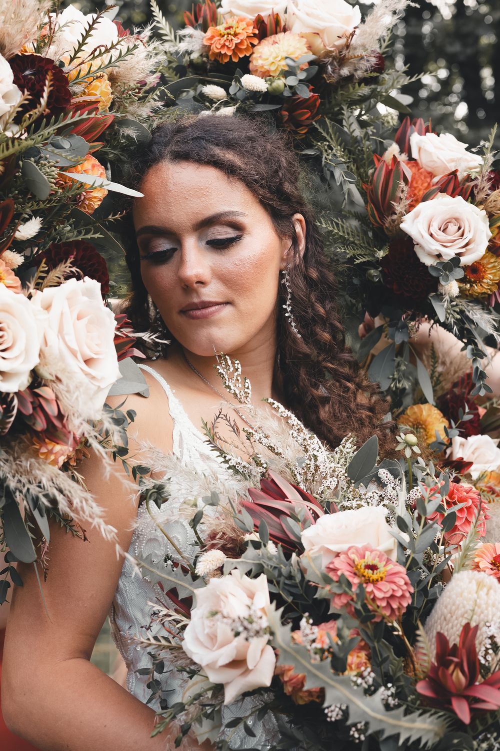 Romantic bridal portrait in Buhl Park, Pennsylvania—surrounded by earthy florals, rich texture, and timeless autumn wedding beauty.