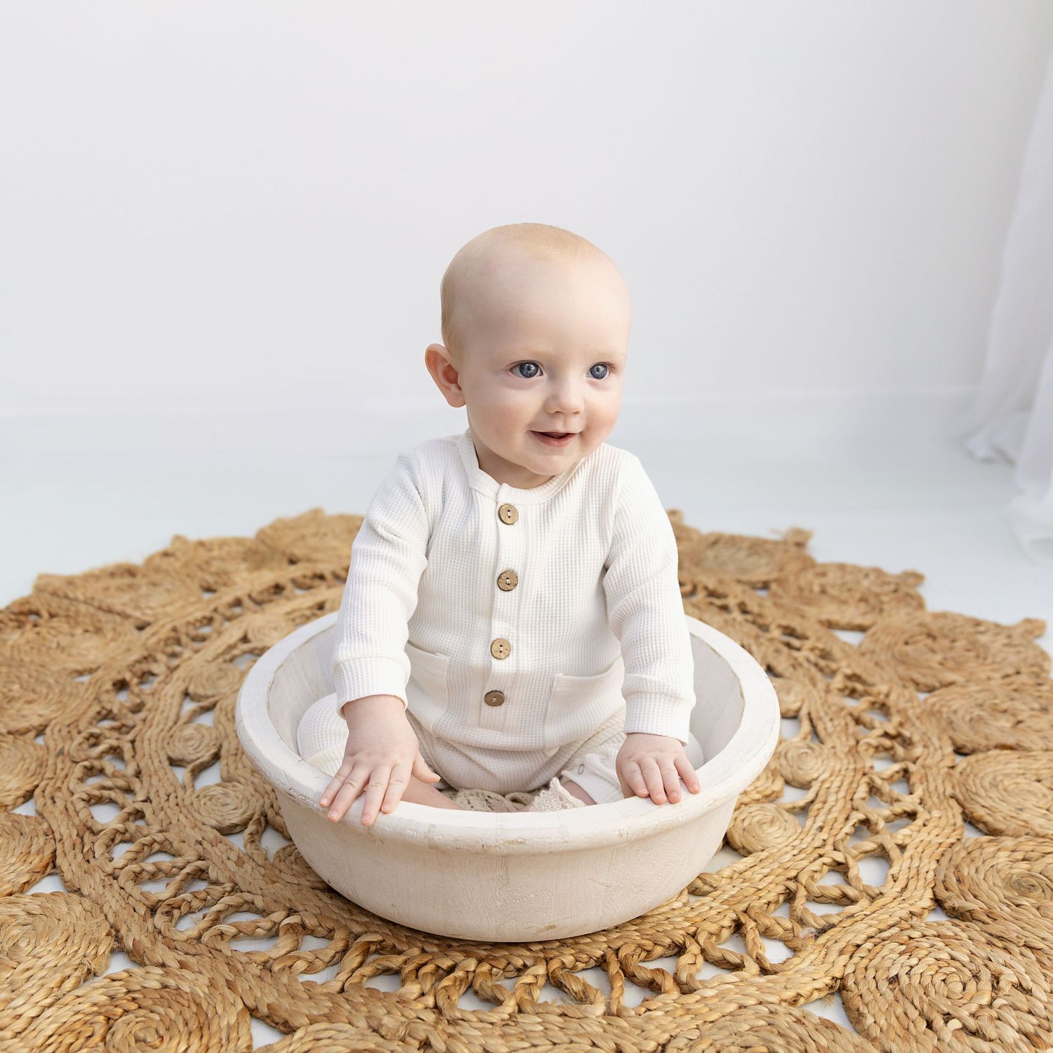 Little boy sitting in a bowl smiling at his sitter session in Coventry with Shelly Loxton Photography