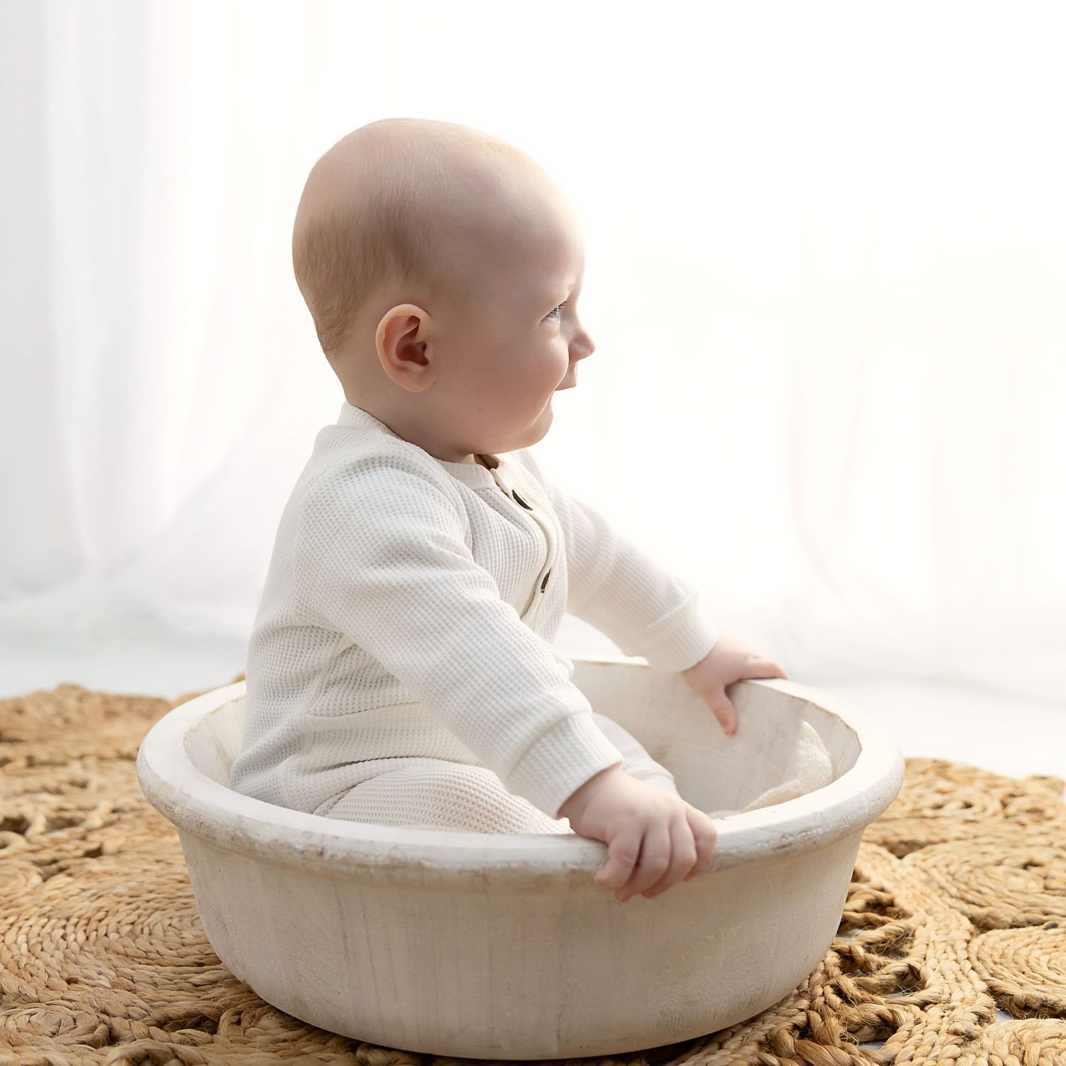 Little boy sitting in a bowl smiling at his sitter session in Coventry with Shelly Loxton Photography