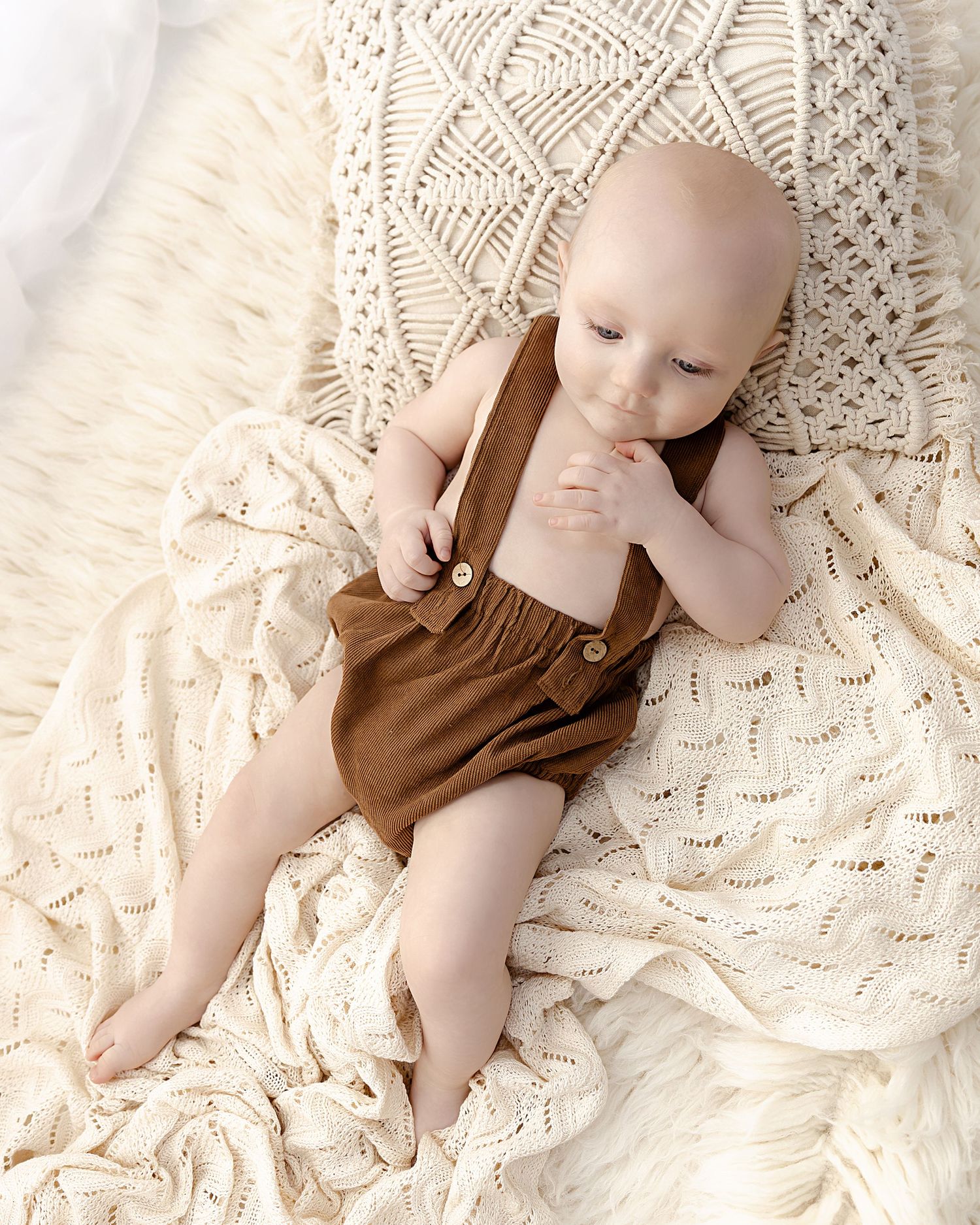 Little boy lying on a blanket at his sitter session in Coventry with Shelly Loxton Photography