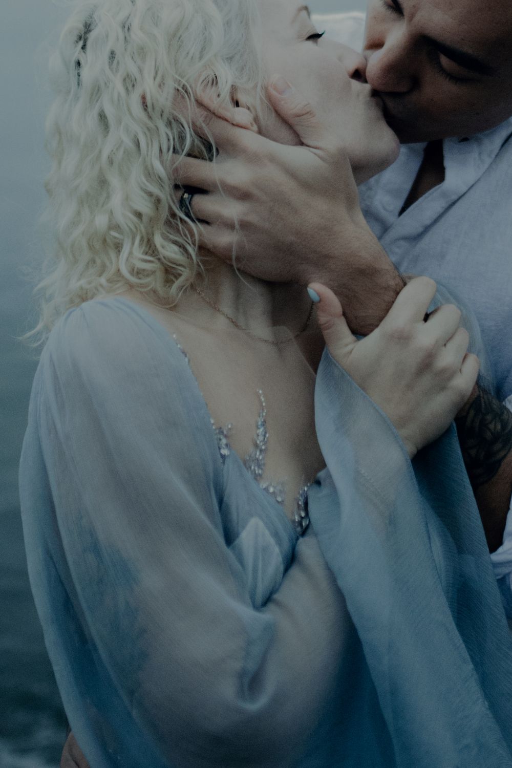 A romantic close-up portrait sequence in soft blue tones showing an intimate moment between two people.