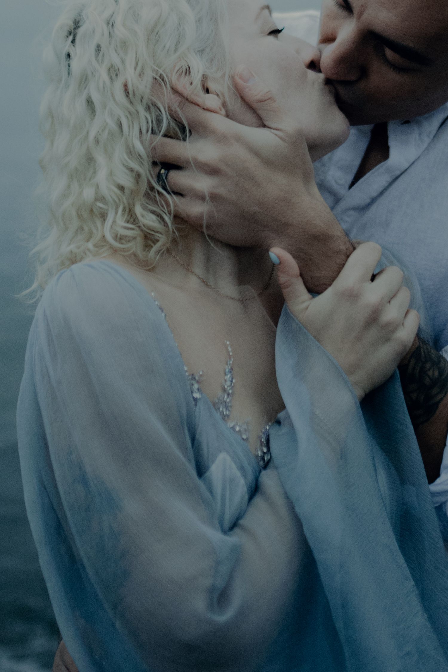 A romantic close-up portrait sequence in soft blue tones showing an intimate moment between two people.