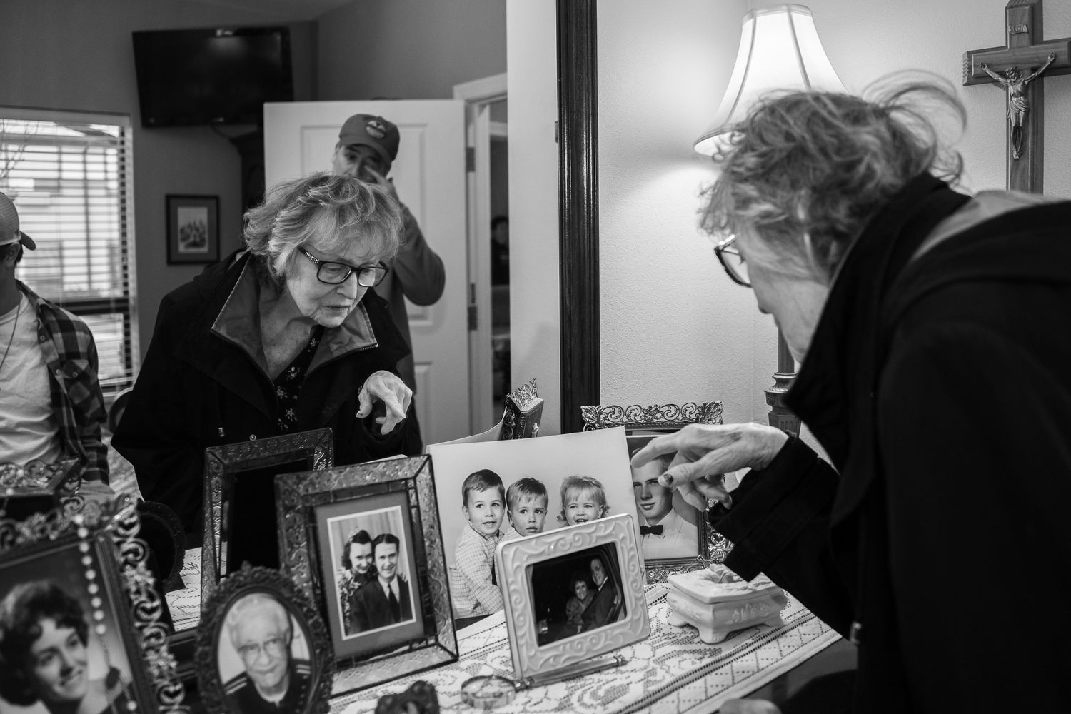 Lifestyle photo of old woman looking at old heirloom photographs taken by Jefferson County TN lifestyle photographer