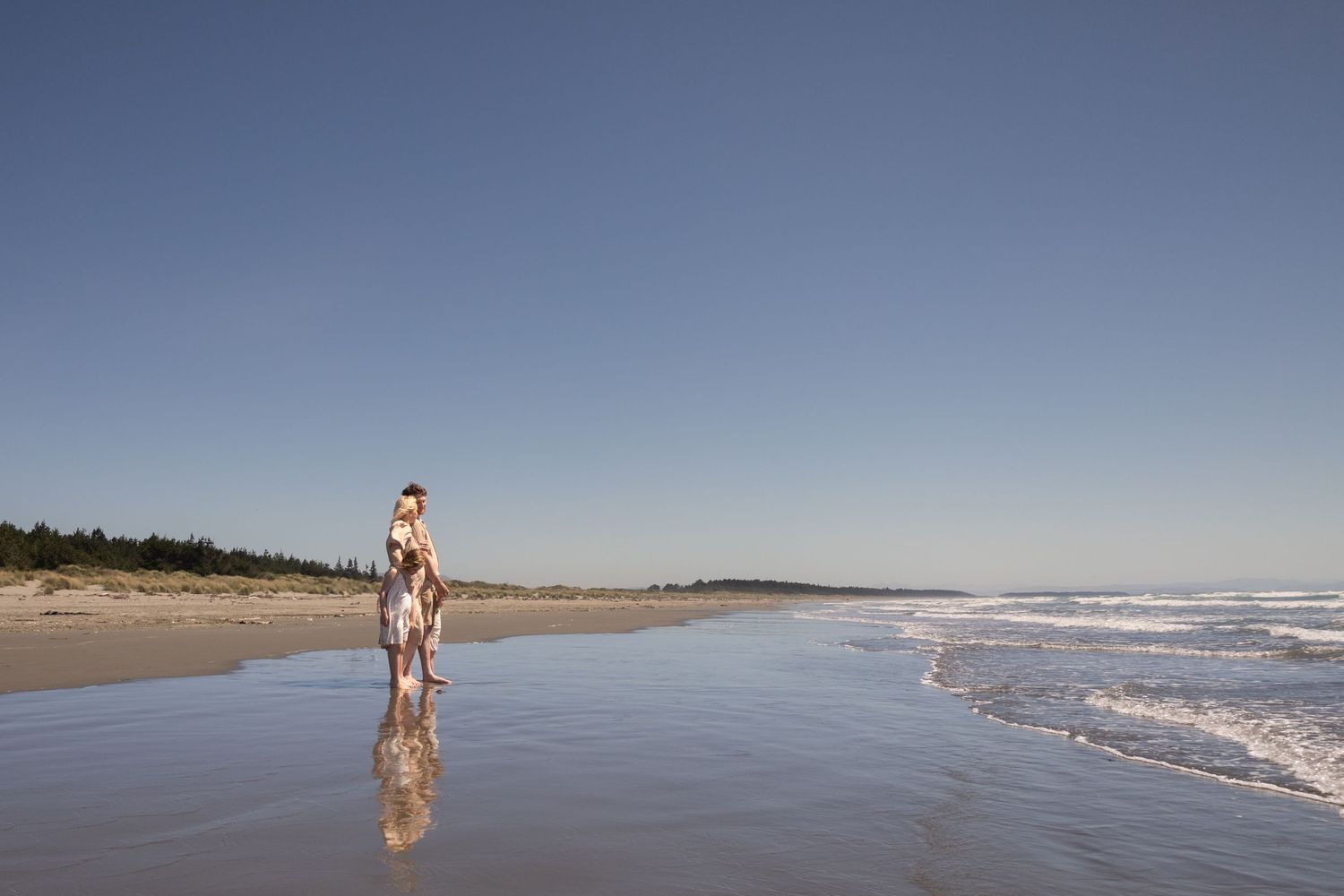 family maternity session at the beach, enjoying the views