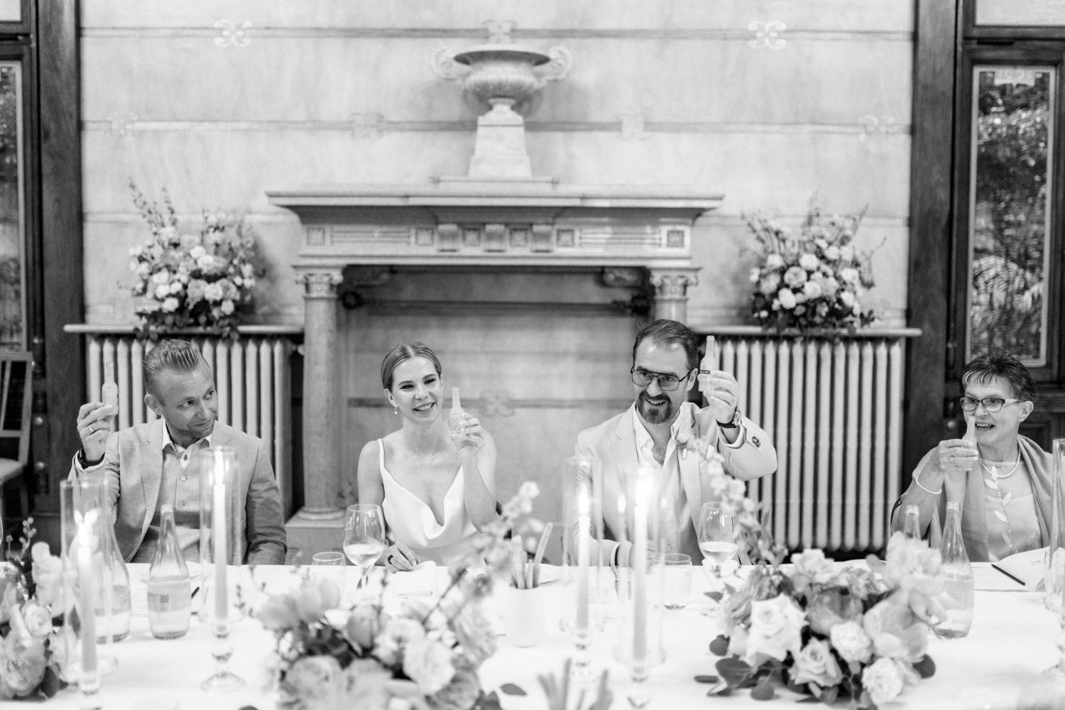 Bride and groom celebrating their intimate elopement having dinner with their guests