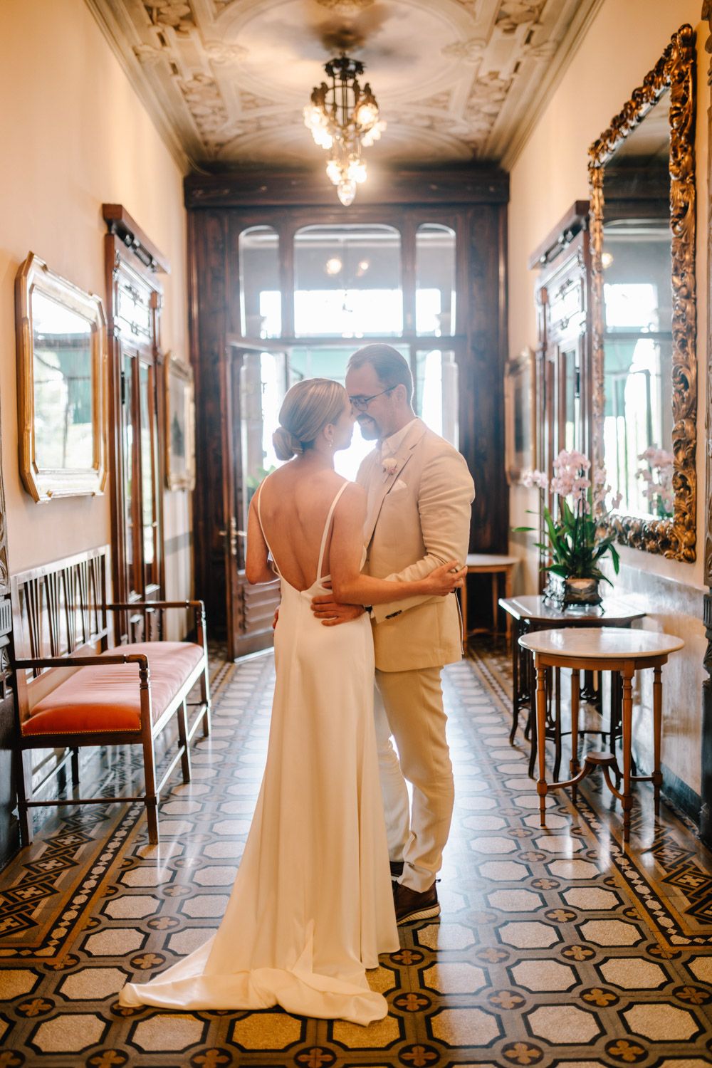 A romantic portrait of the newlyweds inside an elegant frescoed salon with vintage charm
