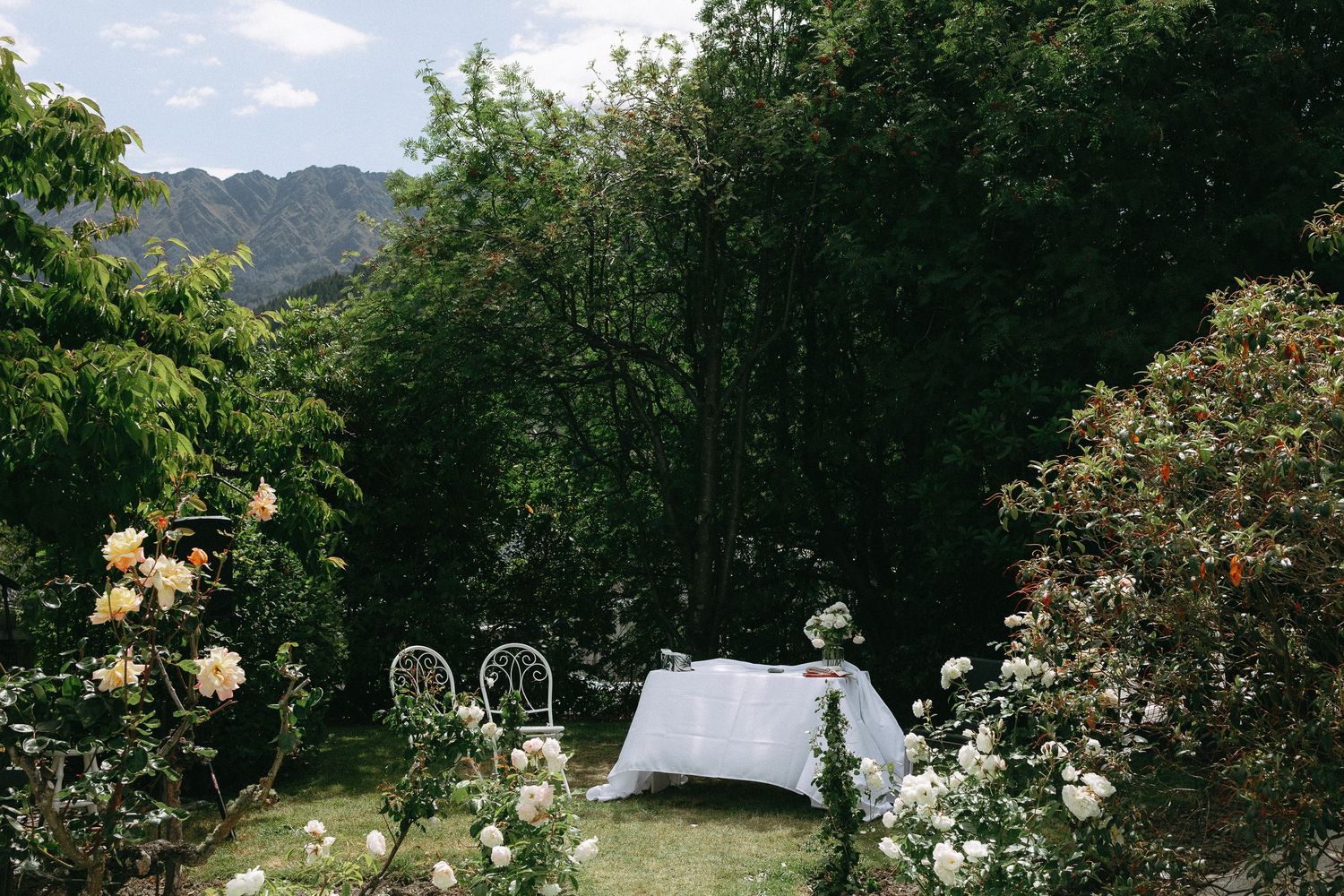An intimate wedding ceremony set up for a backyard Queenstown wedding with scenic mountain backdrop.