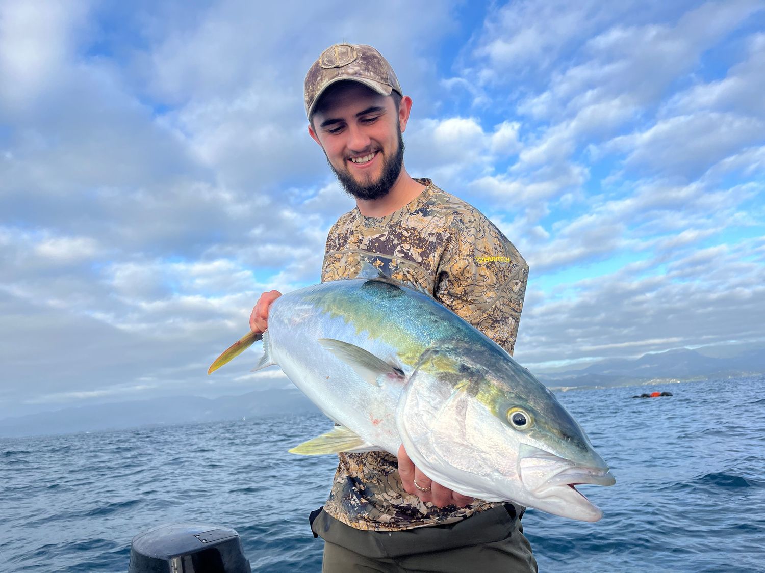 Several large yellowfin tuna caught during deep sea fishing under blue skies.