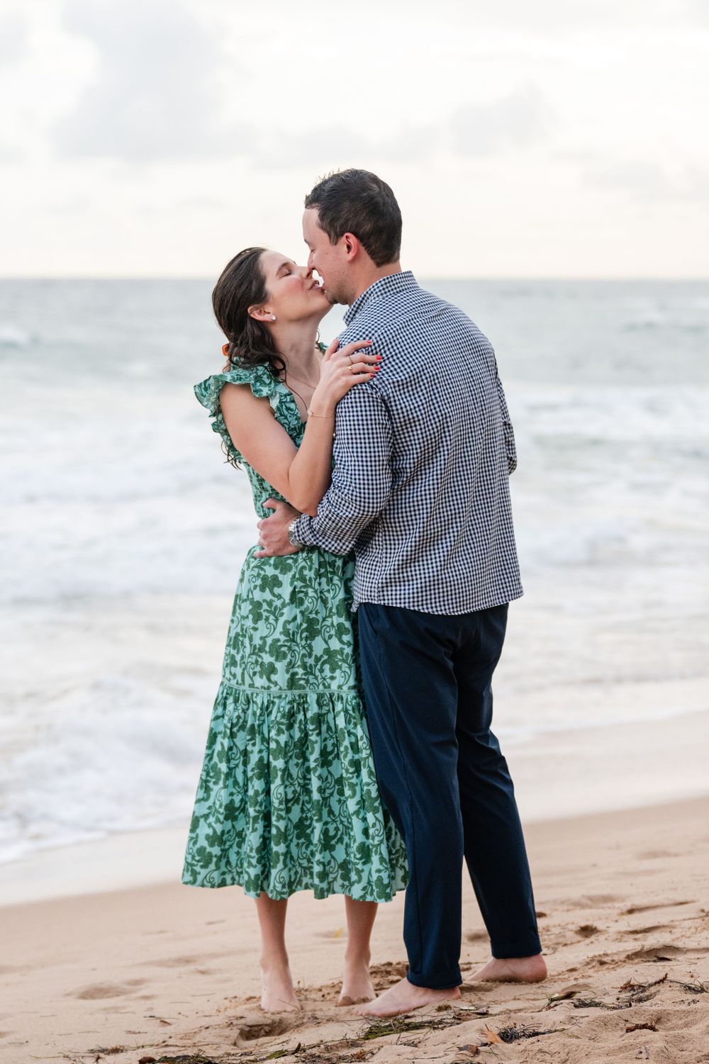 Couple embracing on beach during engagement session at Condado Beach San Juan Puerto Rico