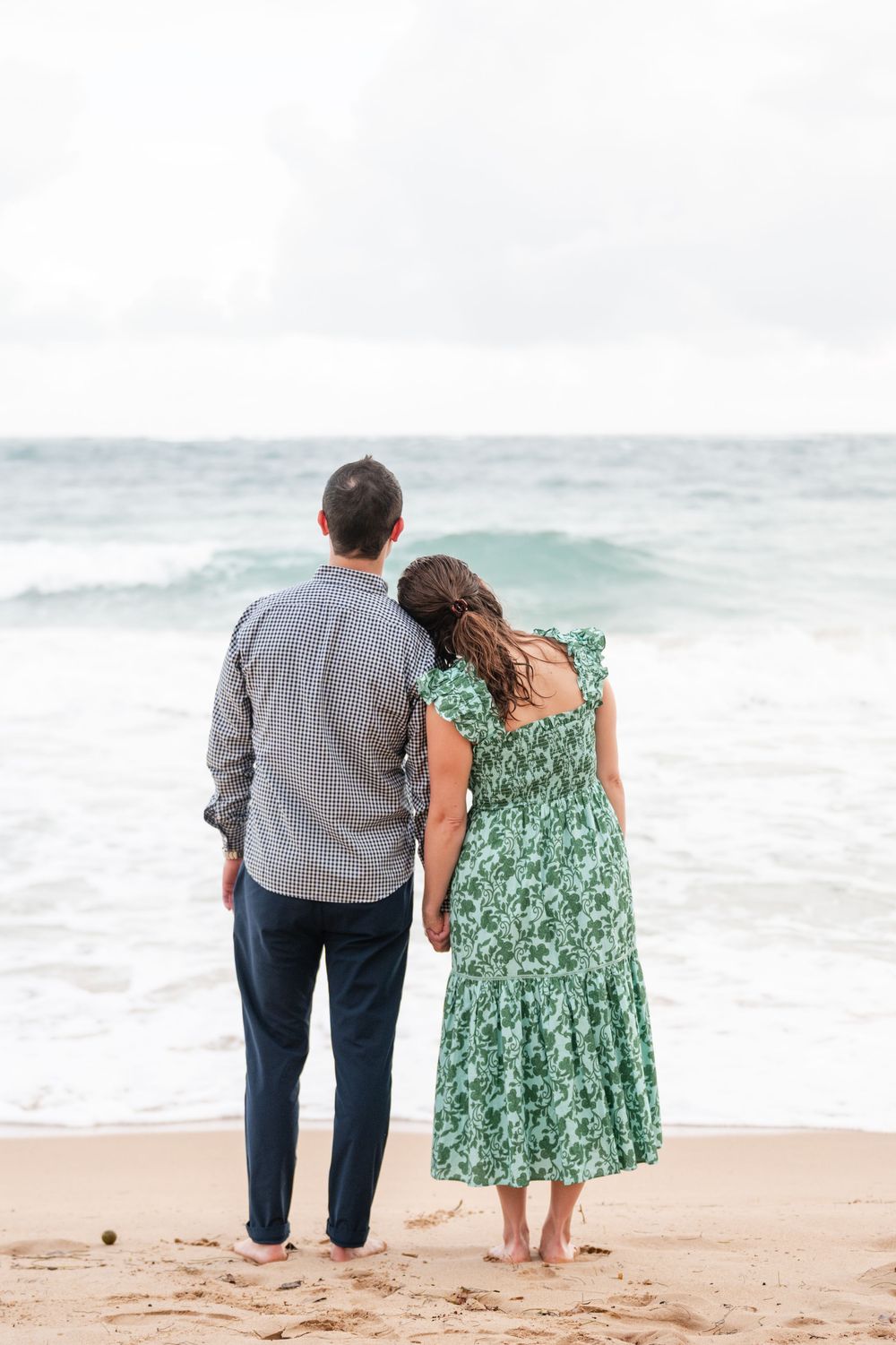 Couple standing together facing ocean during engagement session in Condado Puerto Rico