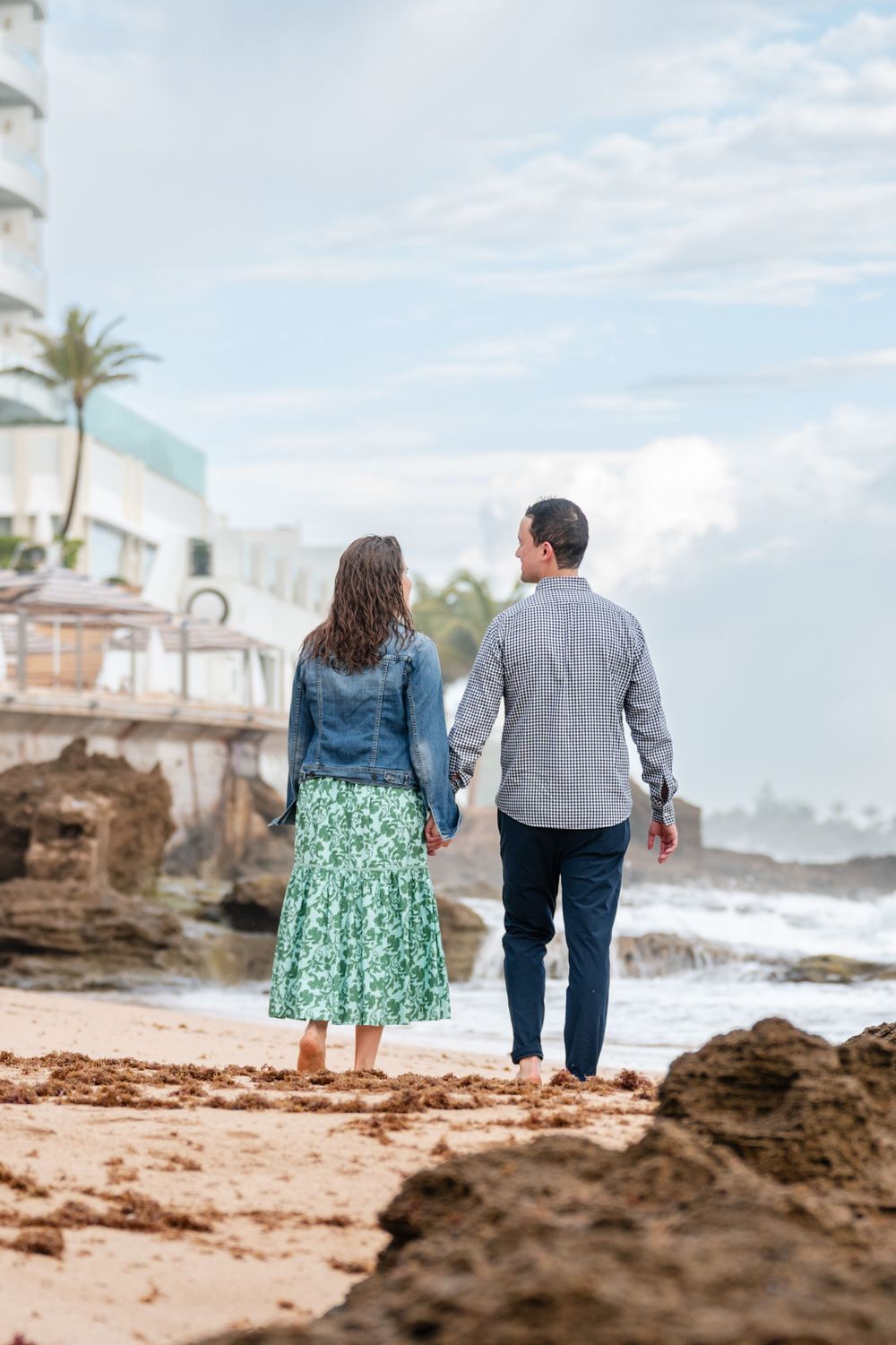 Couple walking away together along beach in Condado San Juan Puerto Rico engagement session