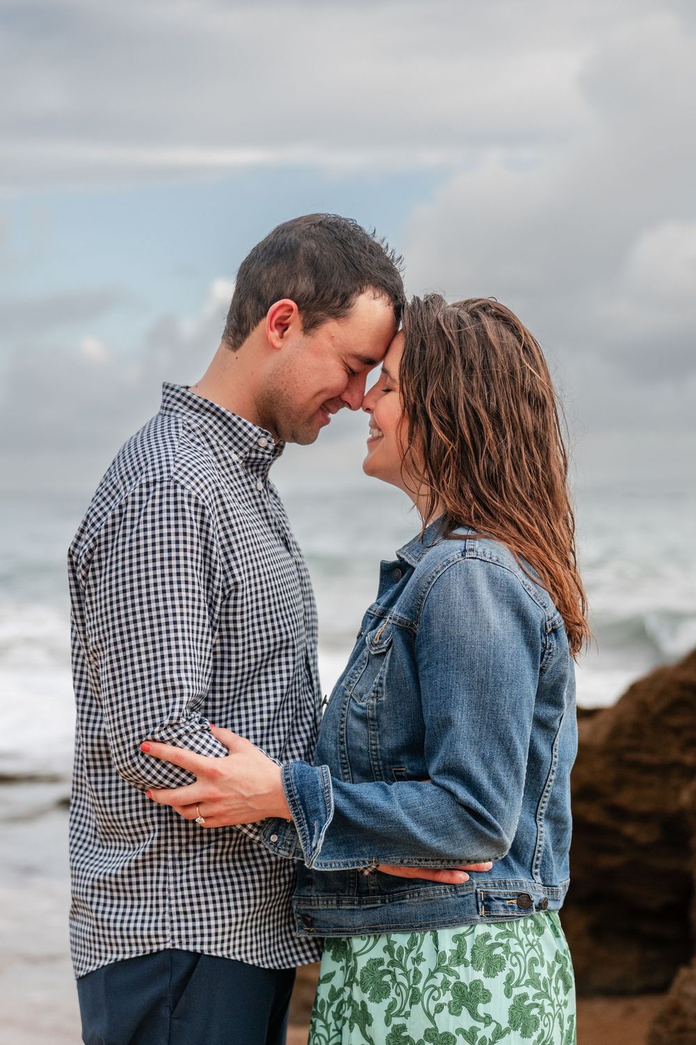 Couple standing close together during engagement session at Condado Beach San Juan Puerto Rico