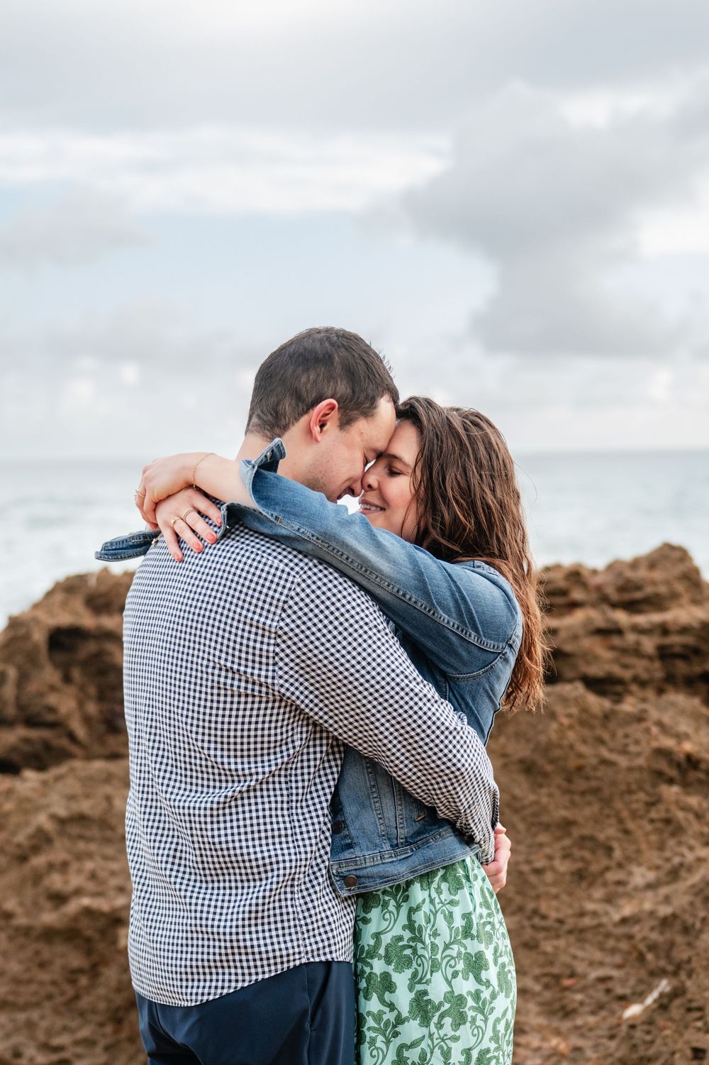 Couple sharing intimate moment during engagement photos at Condado Beach San Juan Puerto Rico