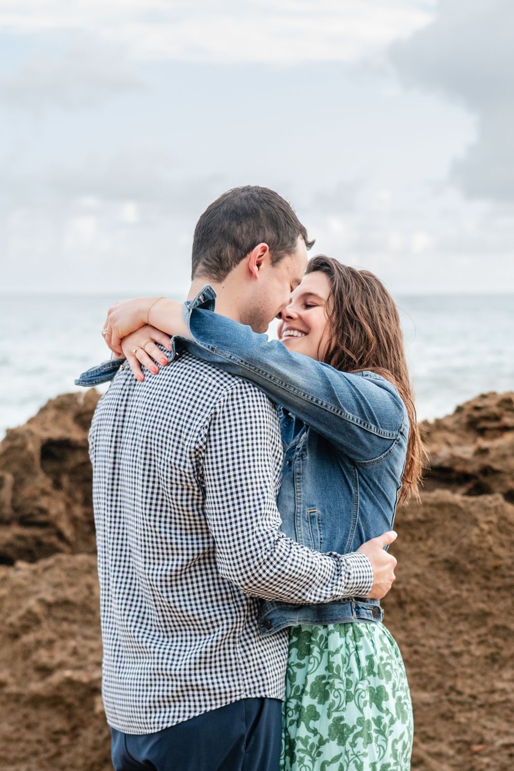 Couple hugging during beach engagement session in Condado Puerto Rico with natural light