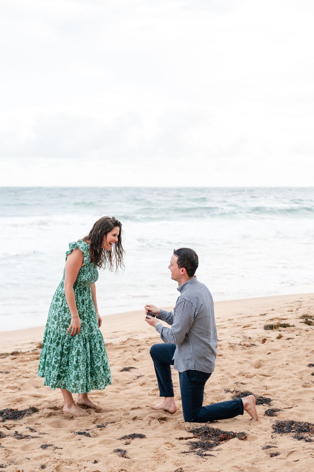 Surprise proposal moment on beach at Condado Beach San Juan Puerto Rico with man kneeling