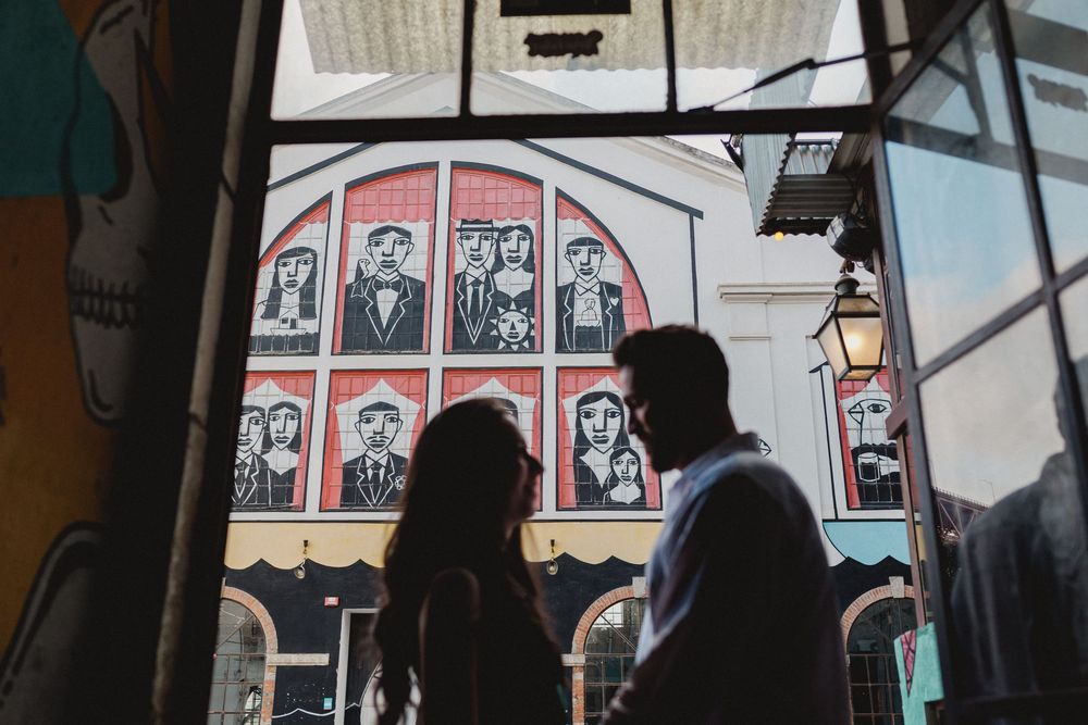 pre wedding photos in Lisbon LX Factory close up couple smiling with urban mural background