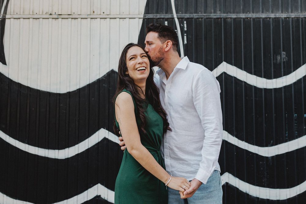 pre wedding photos in Lisbon LX Factory couple standing in front of black and white mural