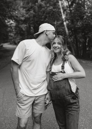 A couple in casual attire shares intimate moments in a series of black and white photos outdoors.