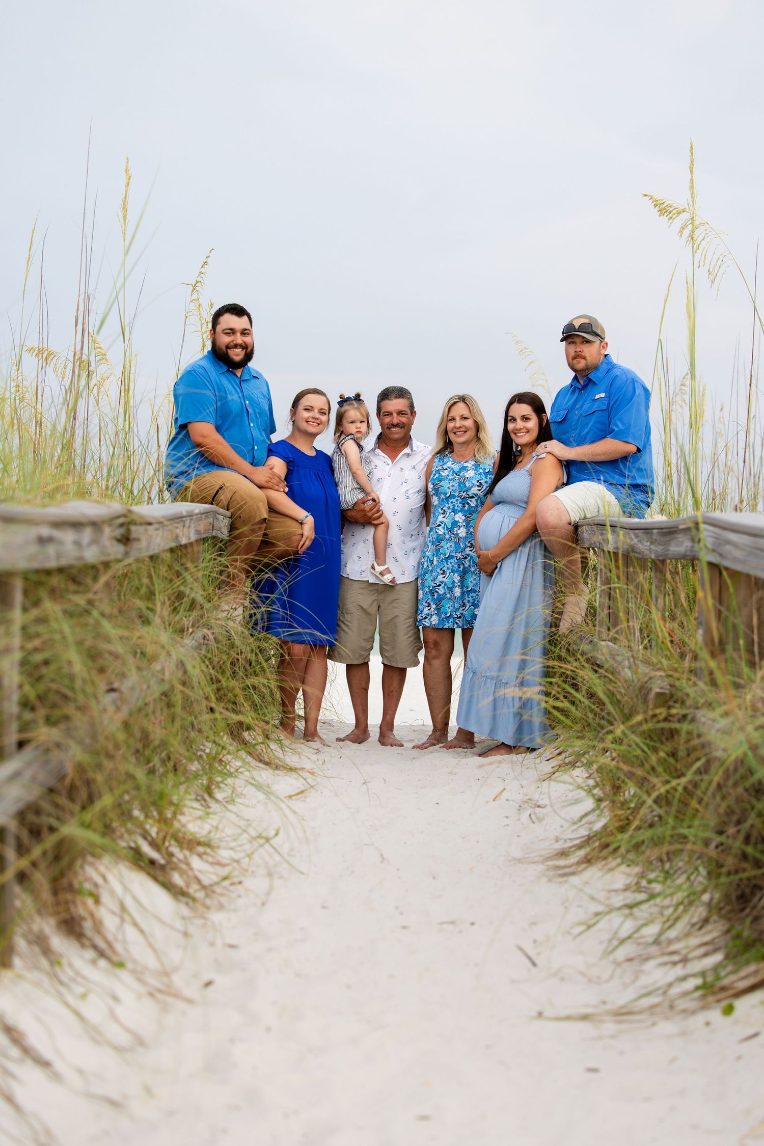 family of seven standing in a beach access point in pensacola
