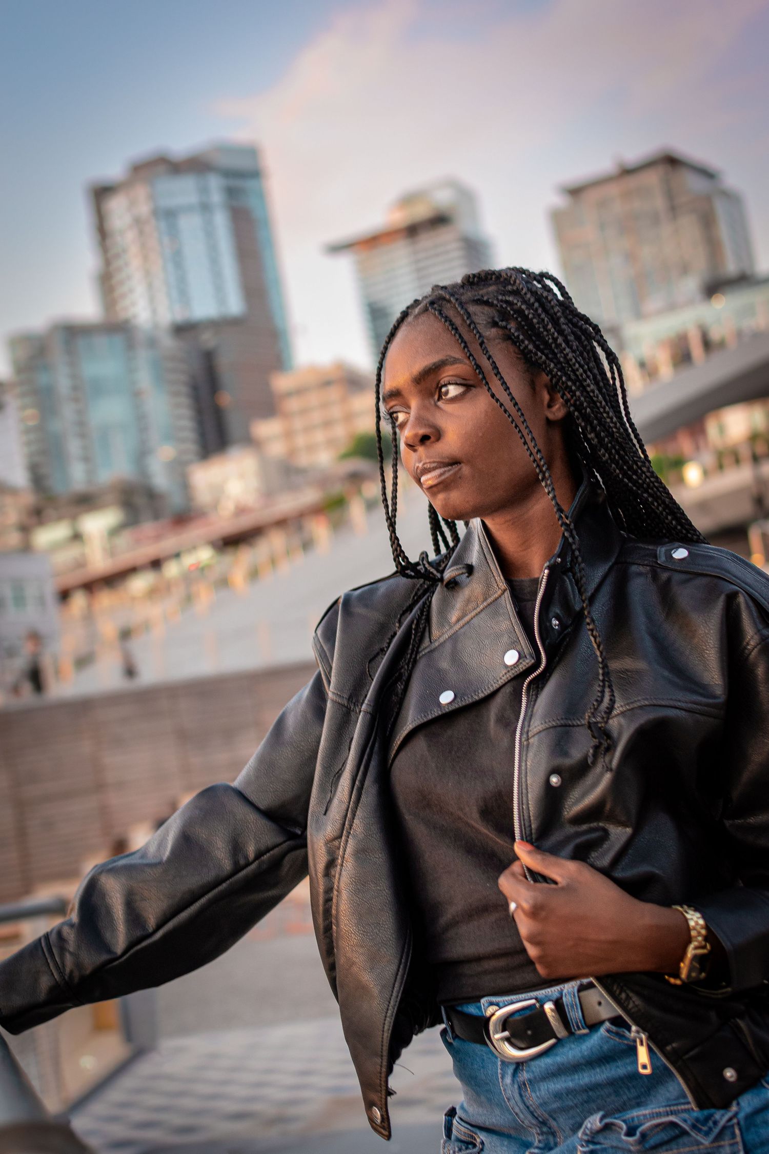Modern outdoor portrait session in Seattle featuring woman posing with city skyline background