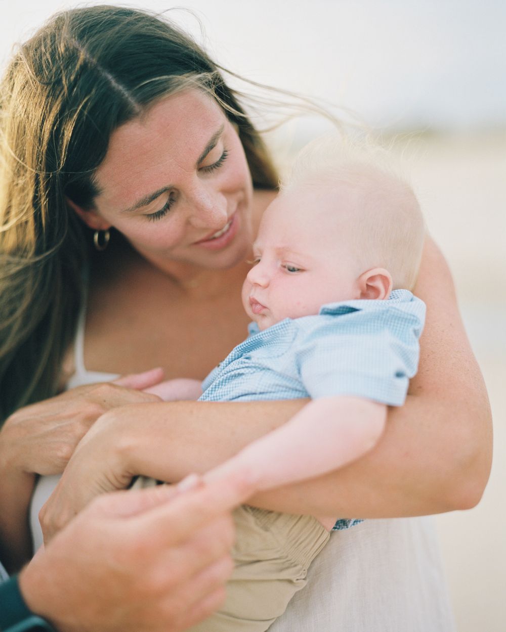 A tender moment captured in a series of photos showing a parent cradling and bonding with a small baby.