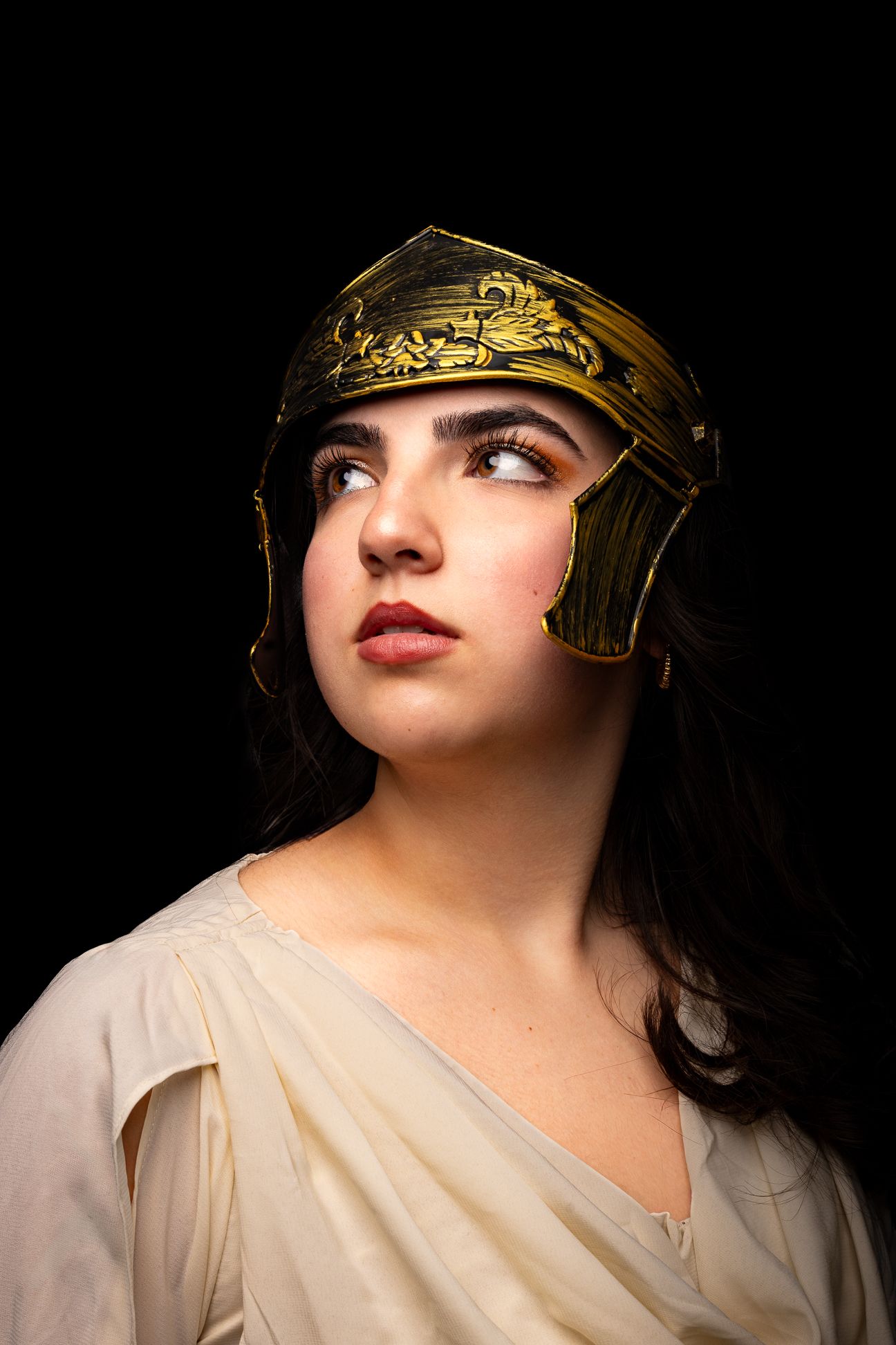 Athena, Goddess of Wisdom, Strategic Warfare, Handicraft and Reason, black backdrop with a girl in a golden helmet looking left (2)
