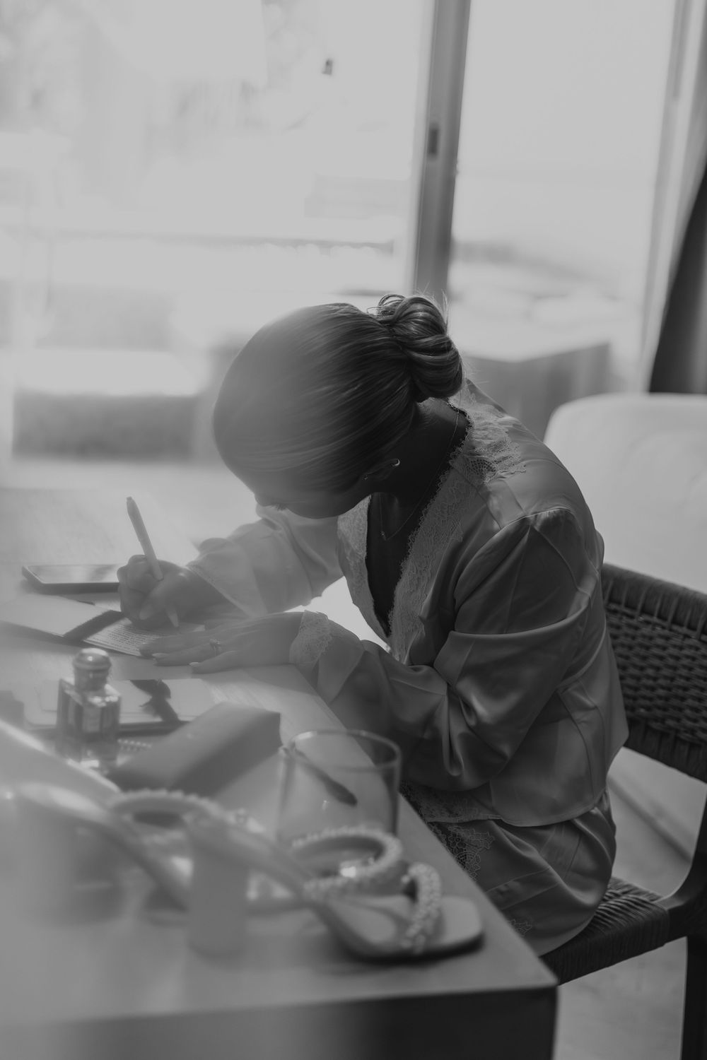 A black and white motion blur sequence shows someone writing or drawing at a desk in progressive frames.