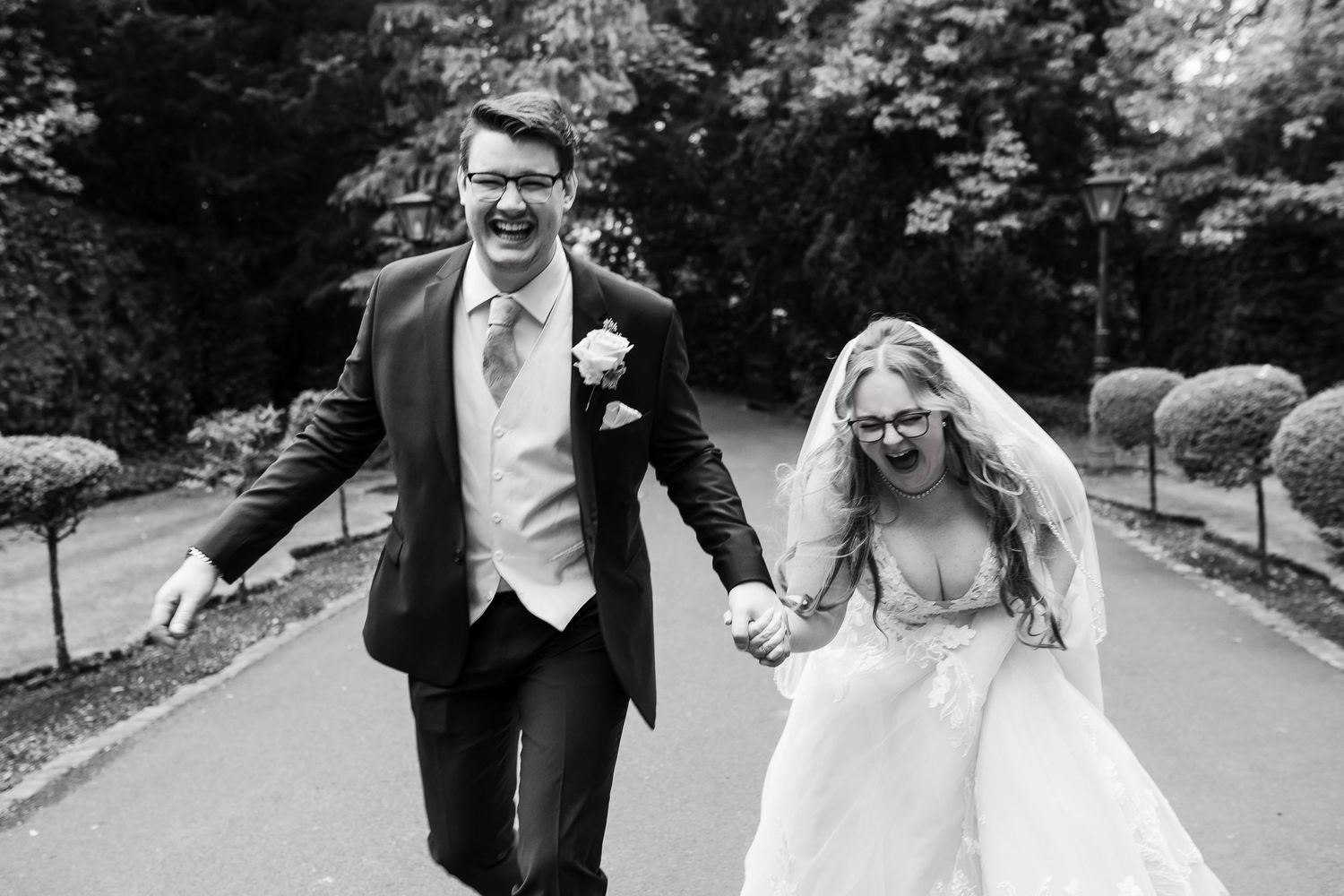 Bride and groom laughing during relaxed Lake District wedding portraits