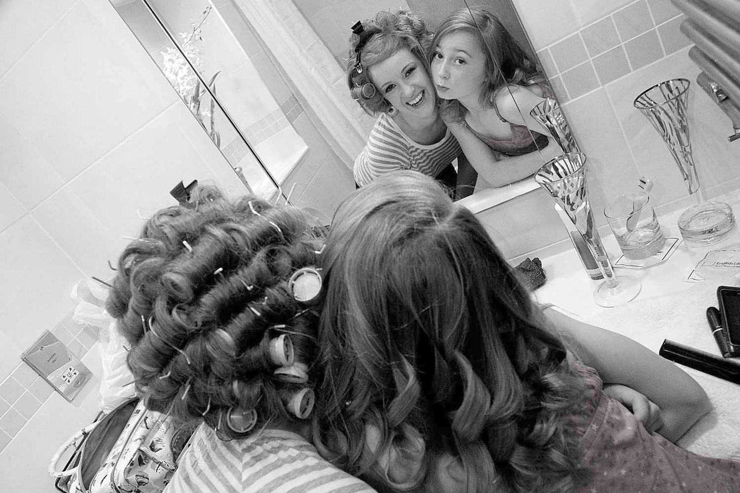 Black and white photo showing the bride and bridesmaid getting ready at Low Wood Bay Hotel & Spa