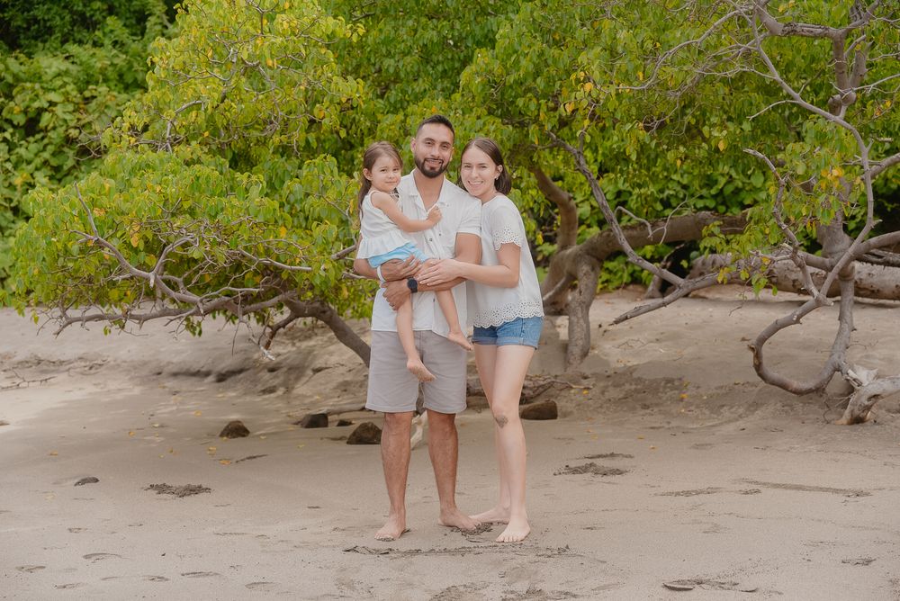 A sequence of photos shows people walking together on a sandy beach path surrounded by lush green foliage.