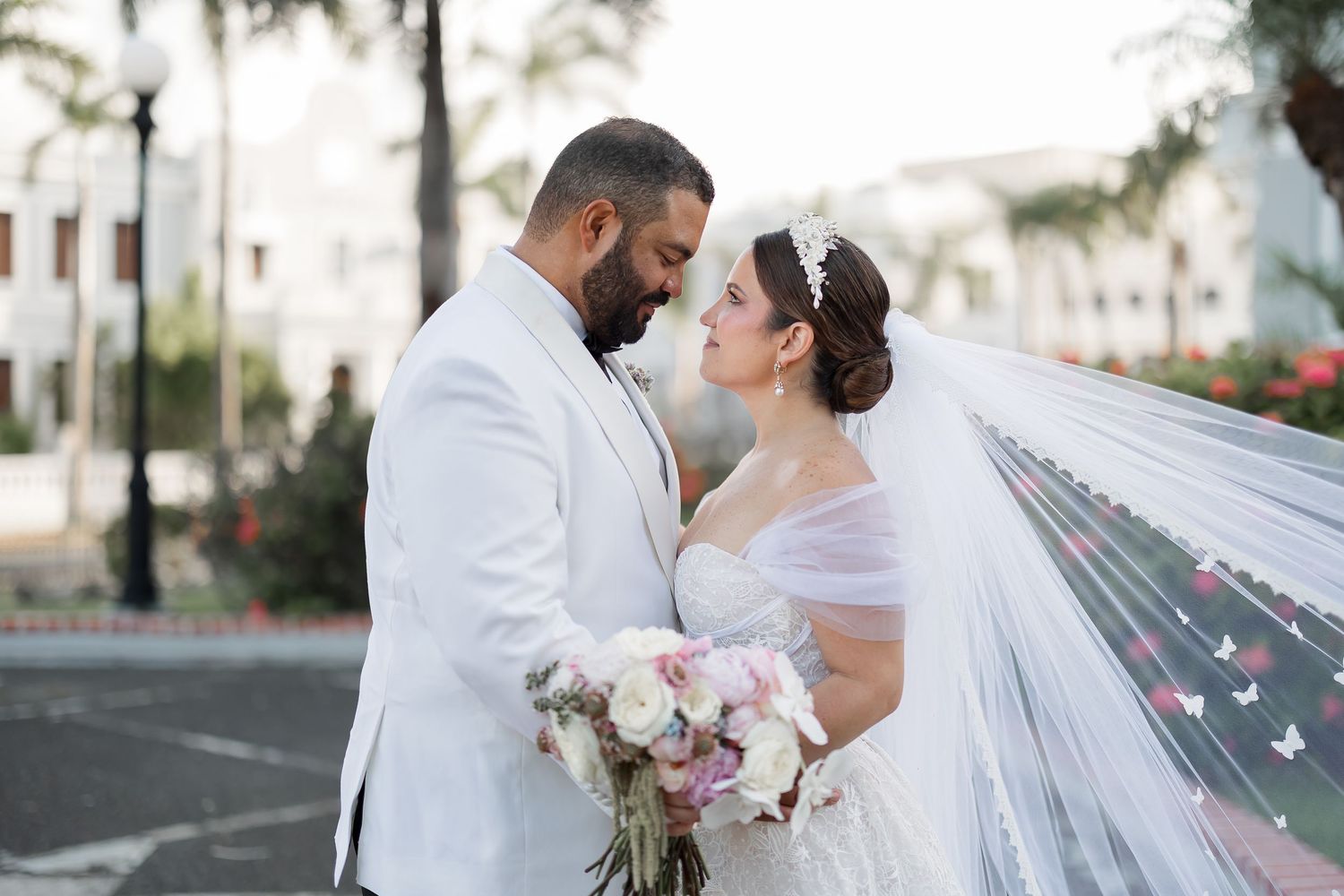 A bride and a groom looking at each other on their wedding day.