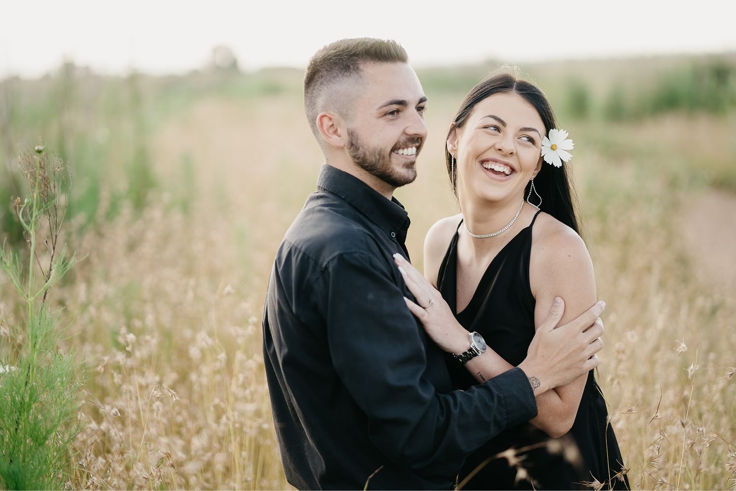 Couple laughing at each other on their city engagement shoot at Sandton City Rooftop in South Africa